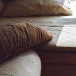 Bed with pillows near a window
